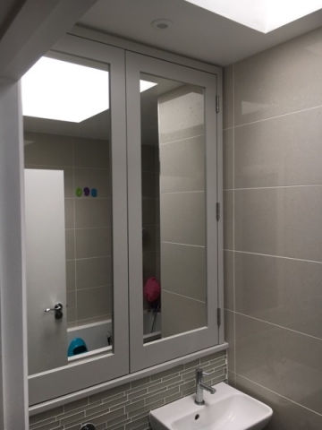 Mirrored bathroom cabinet installed